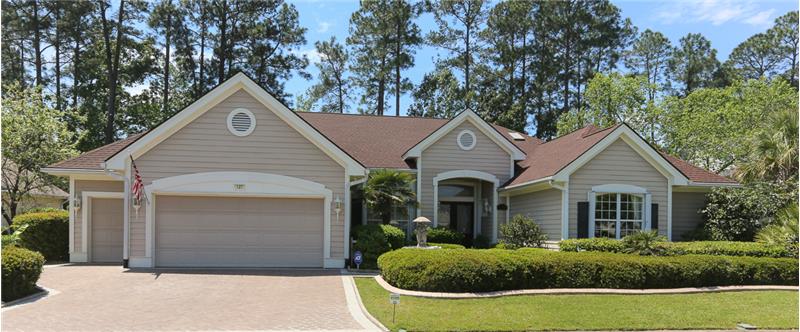 Gorgeous landscaping with a concrete paver driveway and walkway exudes charm and curb appeal in this Del Webb Webster Estate mod