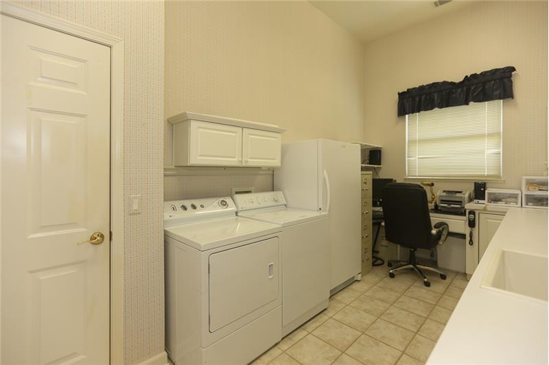 HUGE Laundry room extraordinaire!  This room has tons of counter and cabinet space along with an extra desk for your computer an