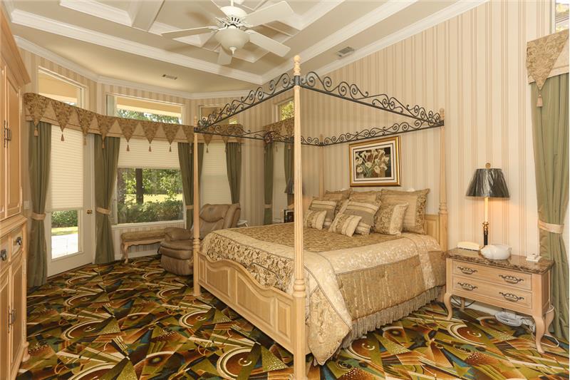Large bay windows with 3M film have custom Hunter Douglass up/down shades in the Owner's suite which has a French door exit to t