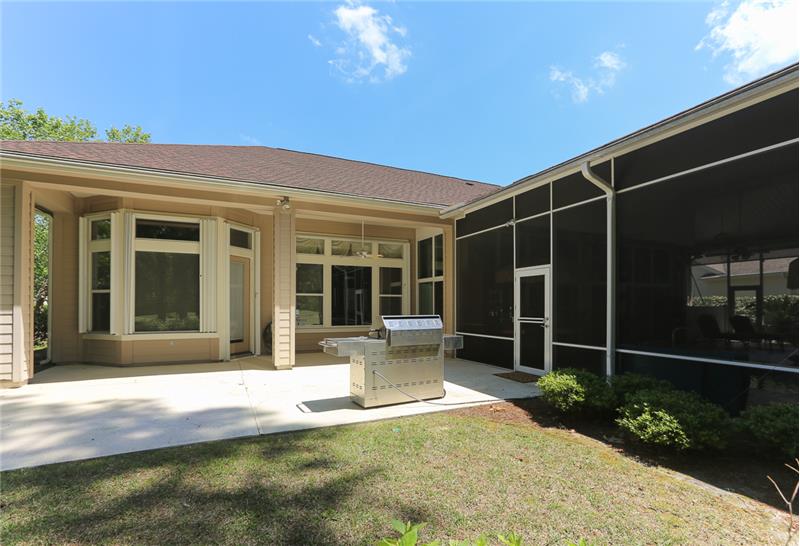 A view from the rear yard to the home and patio.