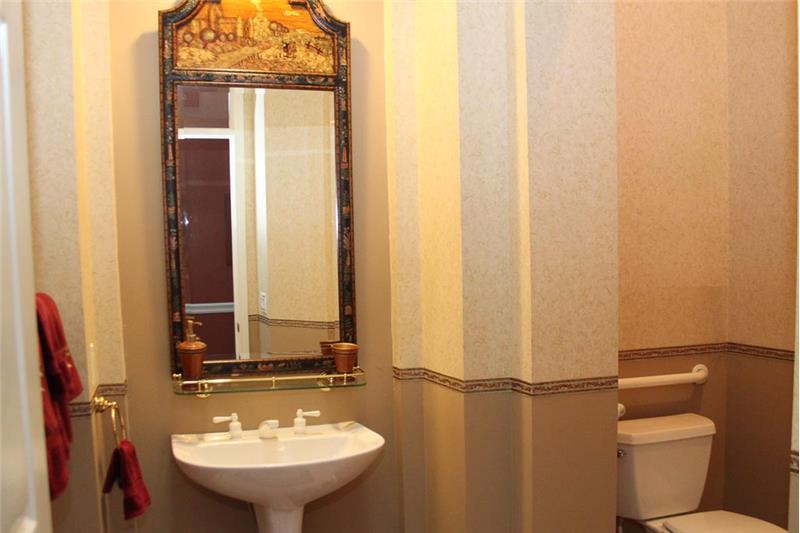 The powder room is inviting and the mirror is included in the sale of the home.