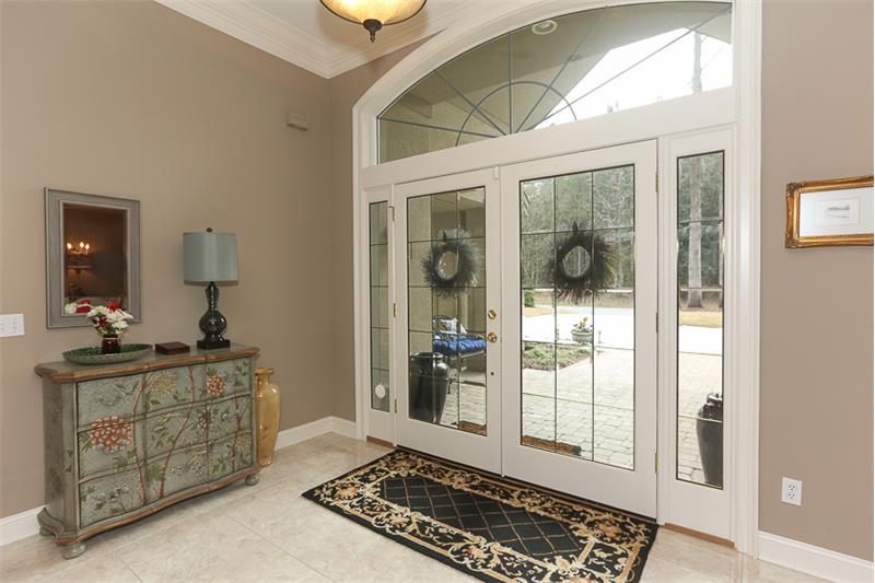 Beautiful entry foyer with double doors and domed transom window