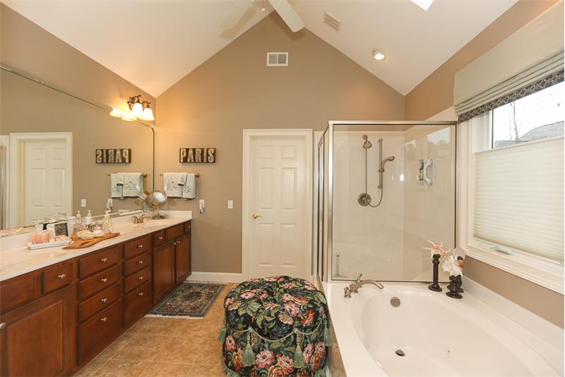 Owners bathroom has a soaking tub and large glass-enclosed shower.