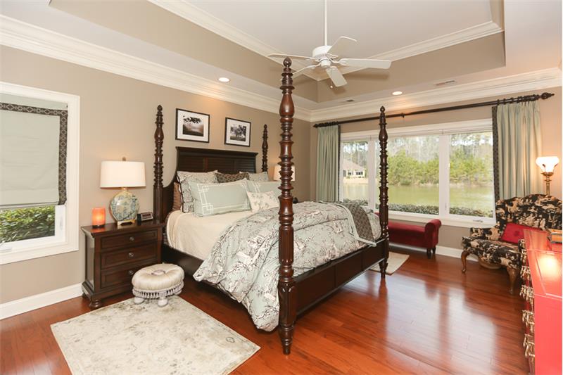 Wood flooring extends to the Owners bedroom with lovely lagoon views.