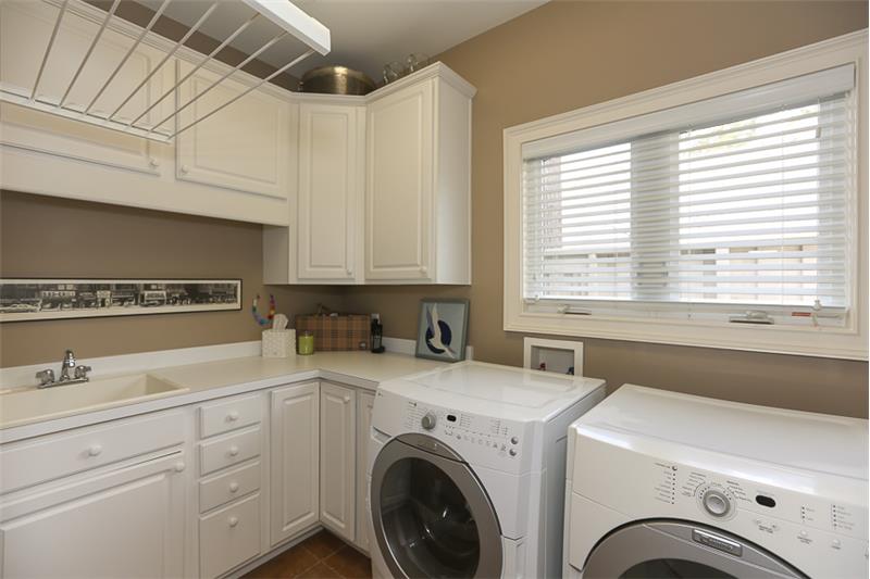 Lovely laundry room with 2 windows and lots of cabinet space