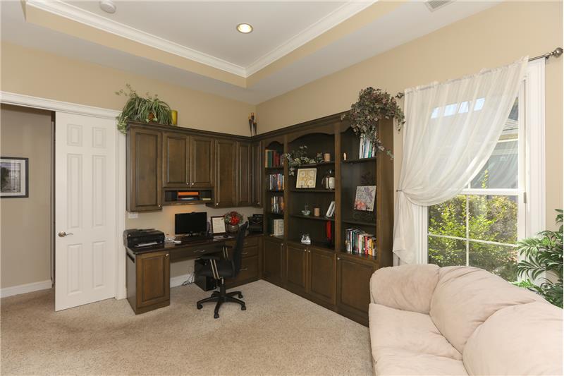 The den has a beautiful built-in desk with a granite top.