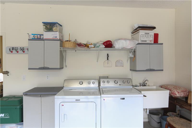 Washer and dryer are currently housed in the garage next to the utility sink