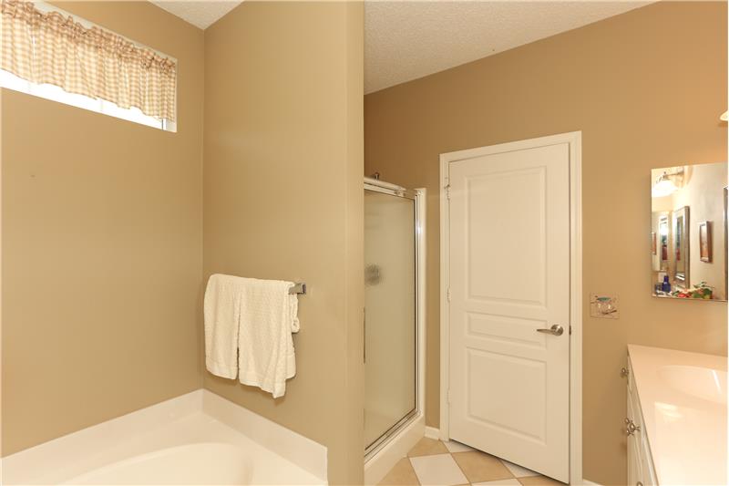 Owners bath has a soaking tub