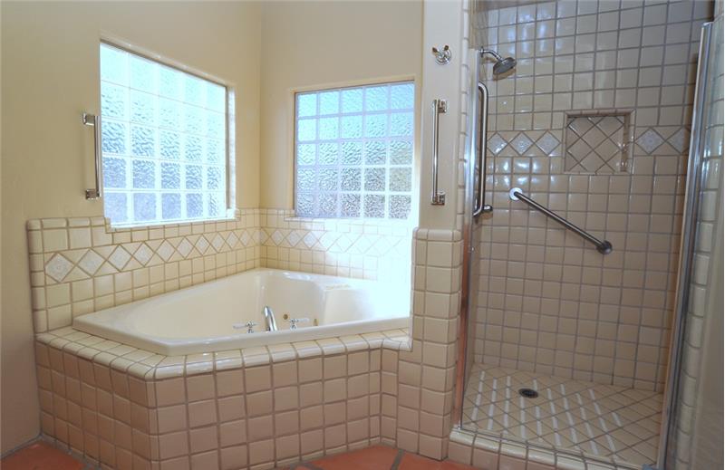 Featuring jacuzzi tub, walk-in shower and glass block.