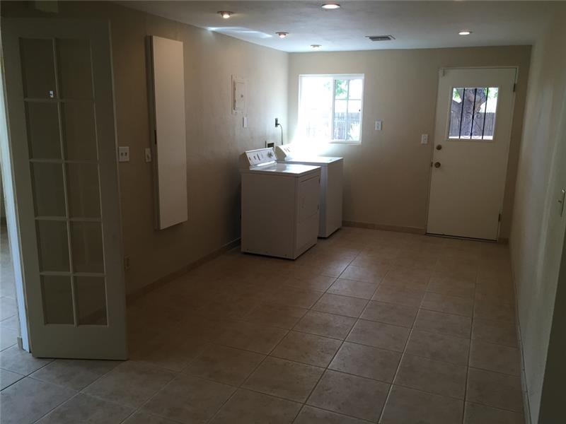 Laundry/utility area with exit to covered patio is large enough for many uses