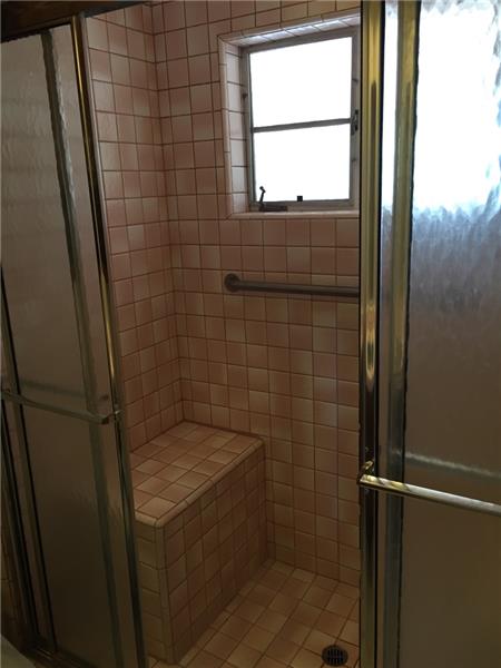 Master walk-in shower with dual benches