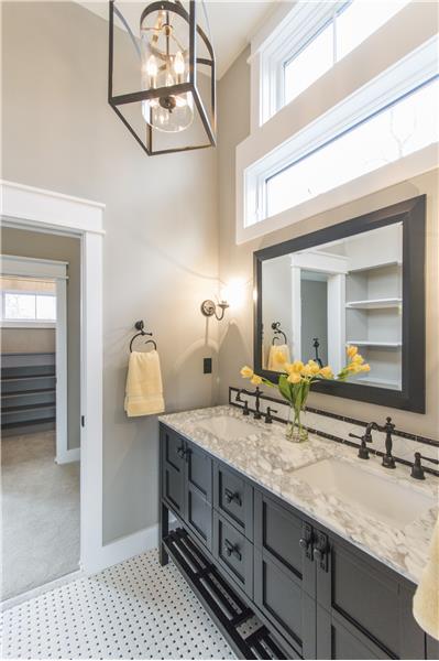 Jack and Jill Vanity area with pair of pocket doors and vaulted ceiling