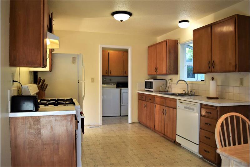 Spacious kitchen leads to laundry room and half bath