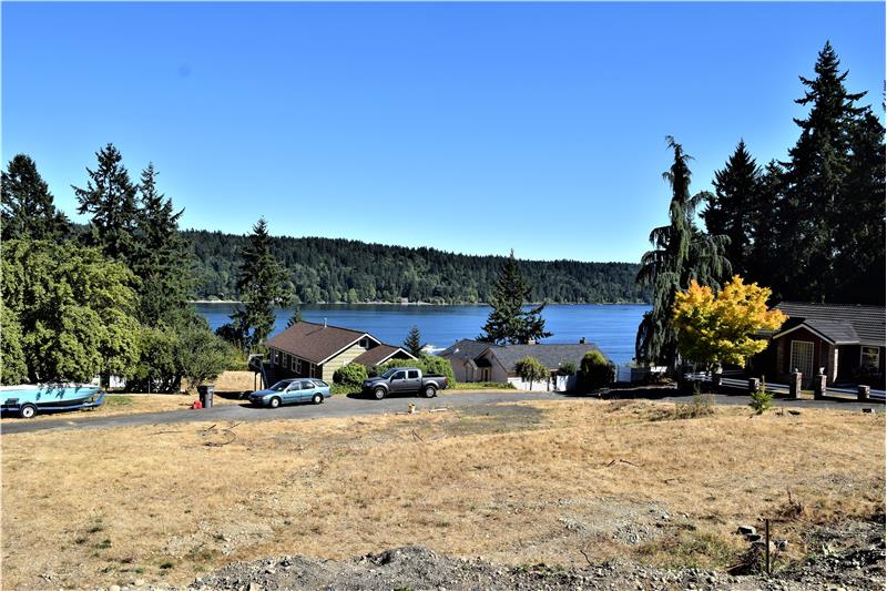 Behind the property facing water.