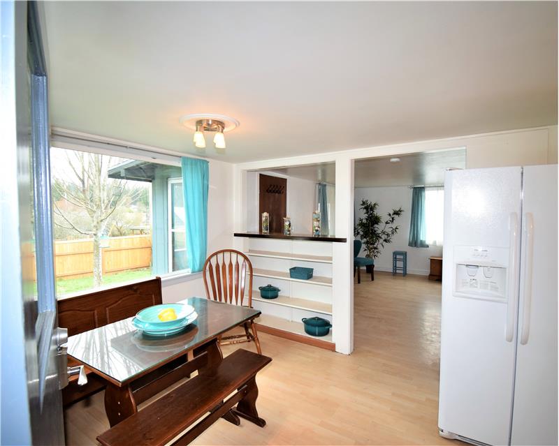 A warm kitchen awaits you upon entry to your super cute home!