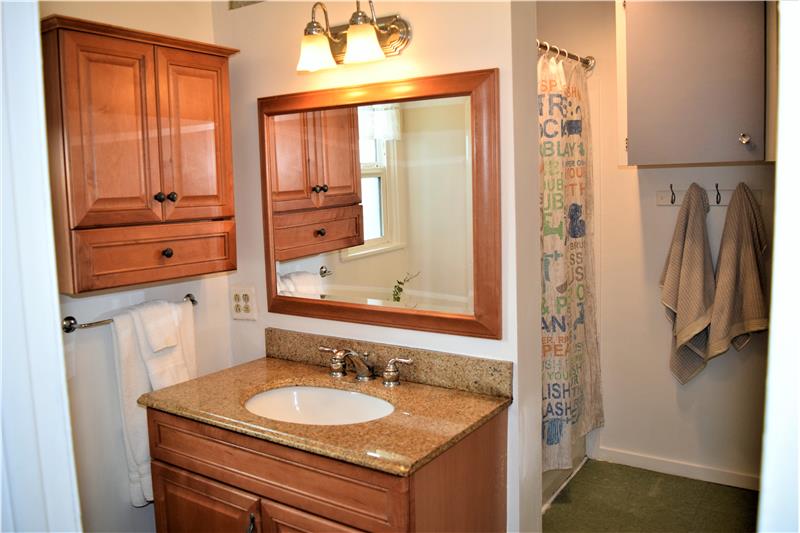 Granite counter on the vanity, and beautiful wood cabinetry give your main bath a high-end feel.