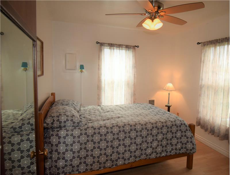 Master bedroom has lots of light, and a lovely new ceiling fan.