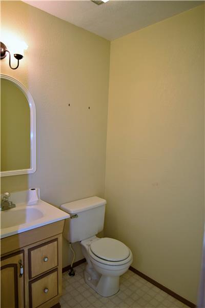 There is also a half bath (pictured here) and laundry room on this level.