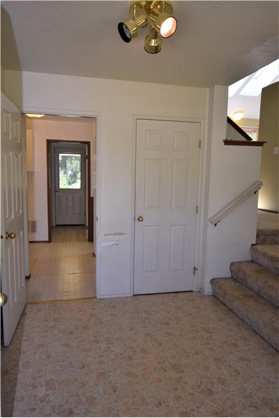Welcome home.  With a little TLC, this place would shine.  The living room is to the right of the main entry.