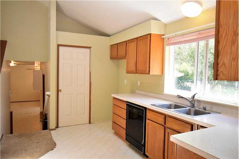 There is a beautiful view of the pond from the kitchen window.  Down the stairs leads to the family room.
