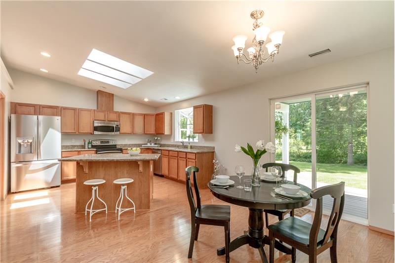 Natural light spills into the kitchen and dining room