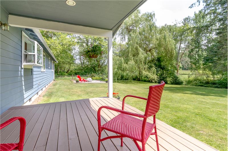 Covered deck overlooks backyard
