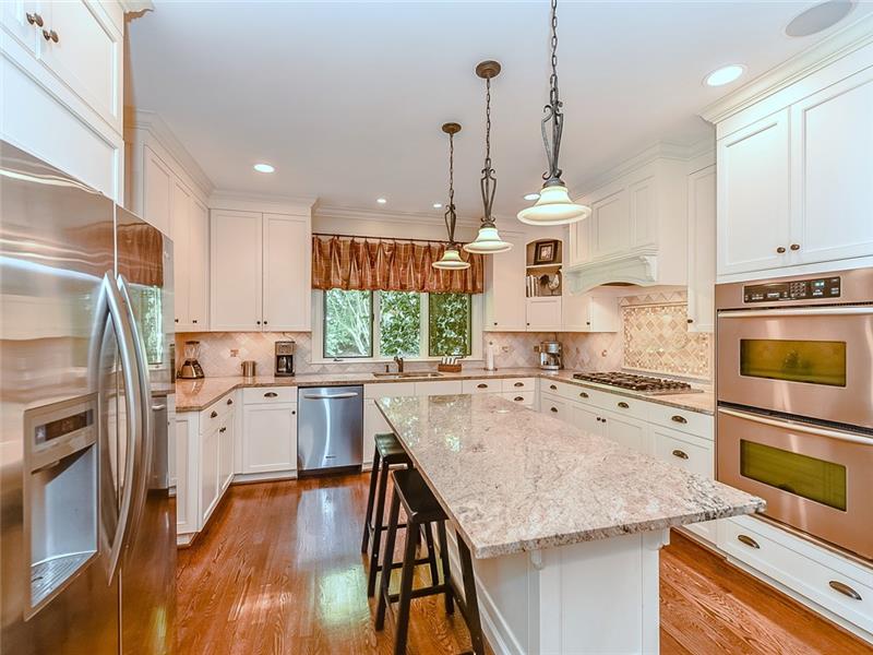 Remodeled kitchen with island, double ovens, walk-in pantry.