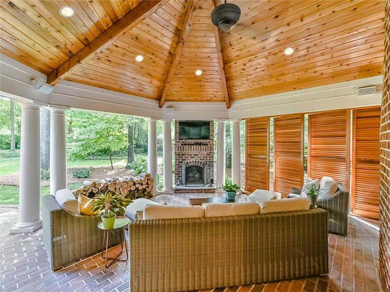 Wood burning fireplace in covered patio.