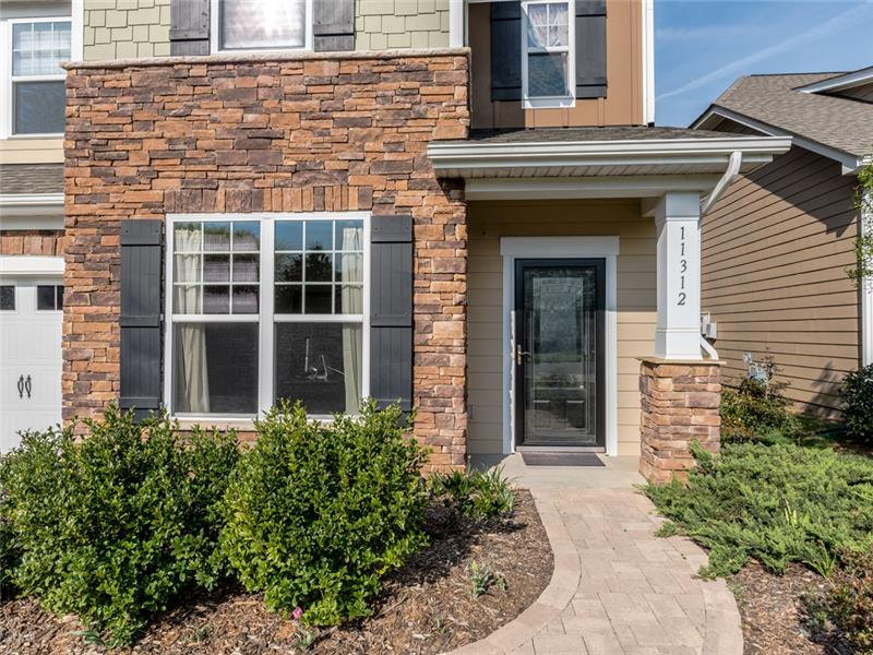 11312 Ardrey Crest Drive: Covered entrance, brick trim, low maintenance hardi-plank siding