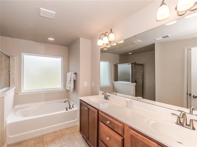 11312 Ardrey Crest Drive: Spa-inspired, en-suite mater bathroom with expansive dual-sink vanity.