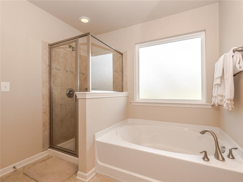 11312 Ardrey Crest Drive: Master bathroom features large soaking tub, separate shower with tile surround, private WC, picture wi