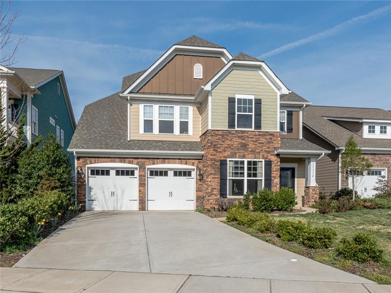 11312 Ardrey Crest Drive: 2-car garage with carriage-style doors, driveway with room for additional parking.