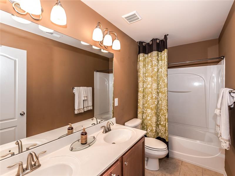 11312 Ardrey Crest Drive: Large bathroom with double-sink vanity shared by the three secondary bedrooms on upper floor.