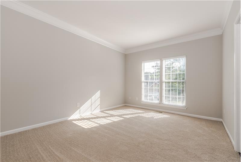 Formal living room with new carpet, new blinds, crown molding, fresh neutral paint.