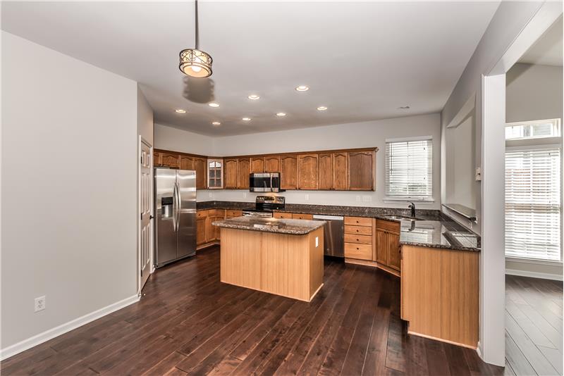 Spacious kitchen with island, breakfast area, pantry.