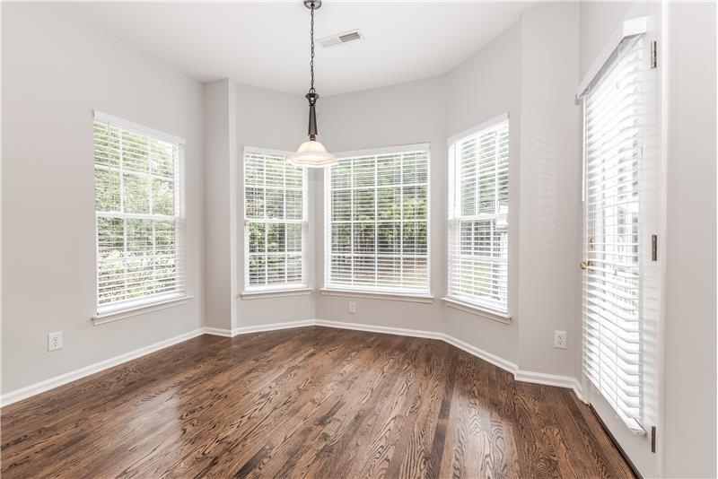 Perfect for daily dining, breakfast area offers just-refinished hardwood floors, fresh neutral paint. French door leads to deck