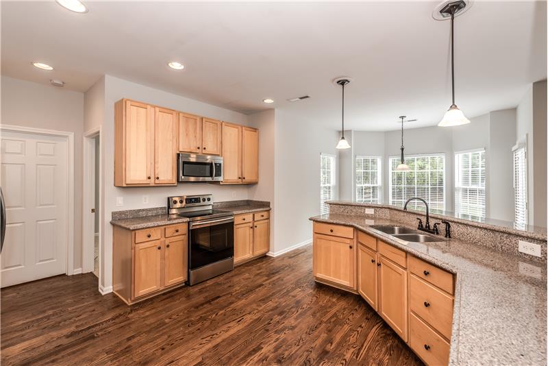 Kitchen provides open sight lines to both the breakfast area and the great room.