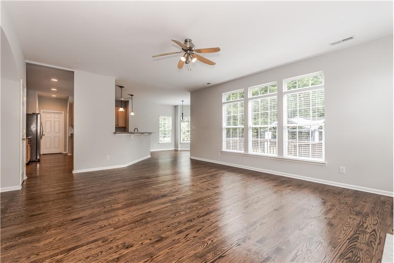 Great room features just-refinished hardwood floors, fresh neutral paint, new window blinds.