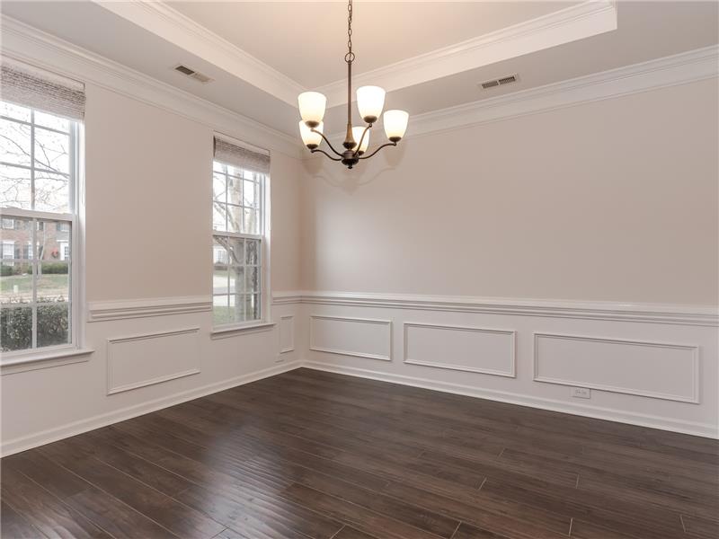 Dining room with new hardwood floors, trey ceiling, chair rail and picture molding.