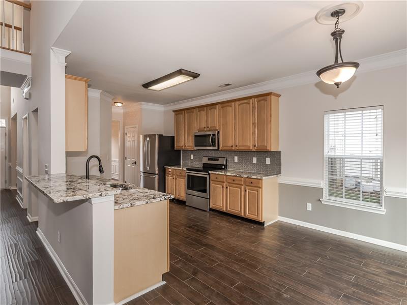 Kitchen has new hardwood floors, new granite counters and tile back-spalsh.
