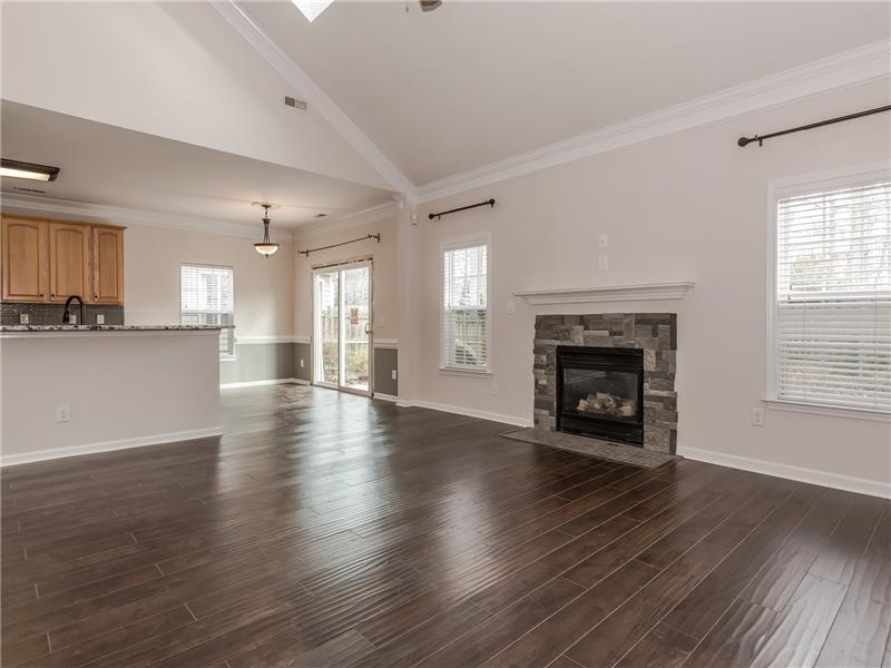 Spacious great room with vaulted ceiling with skylights and new hardwood floors.