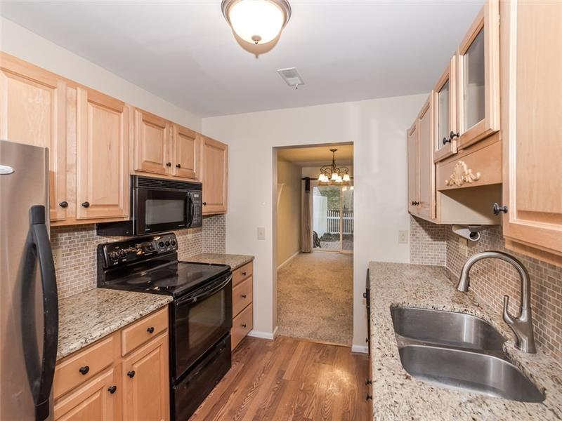 Remodeled kitchen with hardwood floors, updated cabinets.