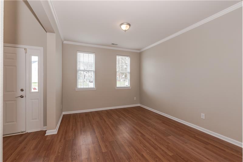 Formal living room with new laminate wood flooring and fresh paint