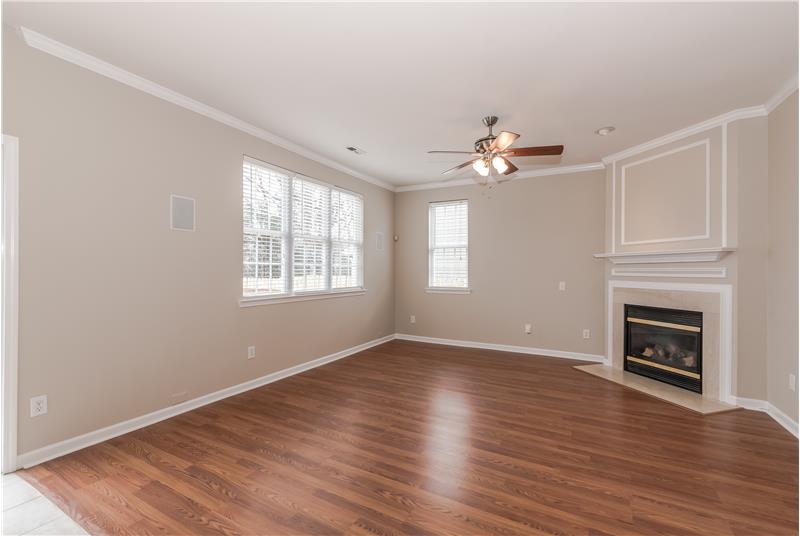 Great room has new laminate wood floors, fresh paint, crown molding, gas fireplace