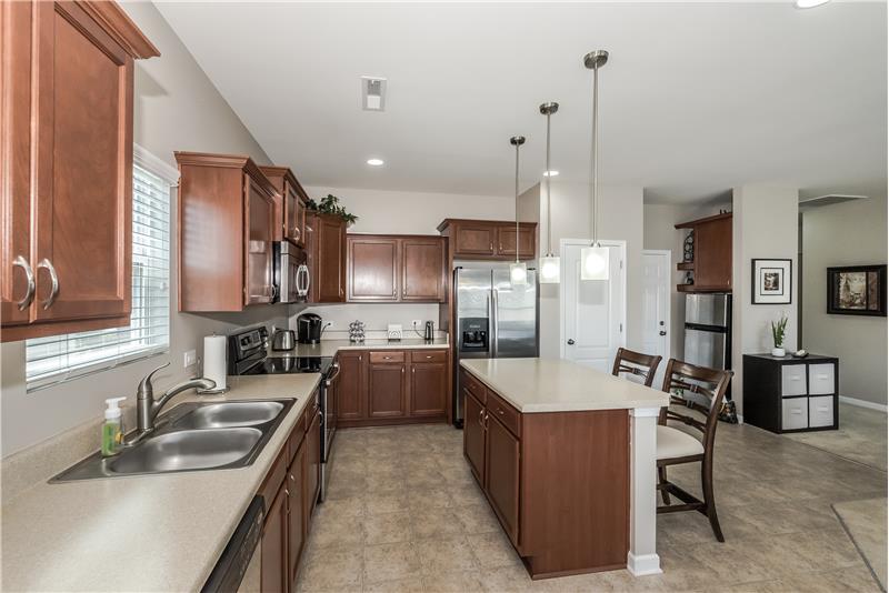 Kitchen offers stainless steel appliances, lots of cabinets, and counters