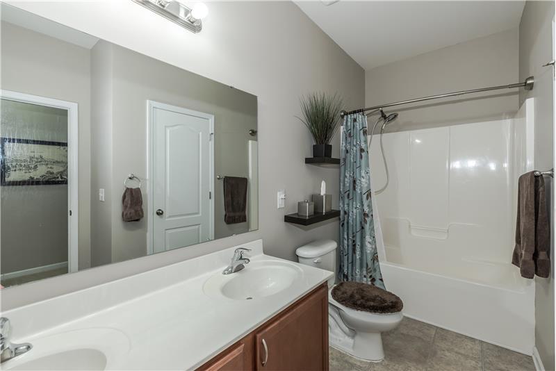 Full bathroom shared by secondary bedrooms features double sink vanity