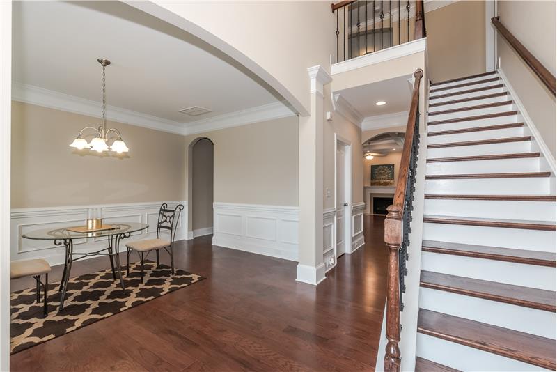 Center-hall style foyer flanked by formal living and dining rooms. Beautiful wood treads and wrought iron rails on staircase.
