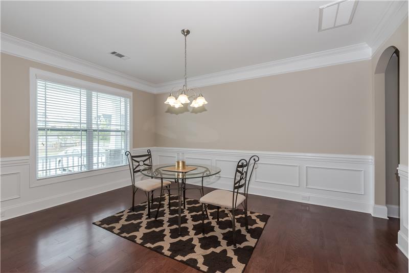 Elegant dining room with generous mill work, gleaming hardwood floors perfect for holiday gatherings and more formal entertainin