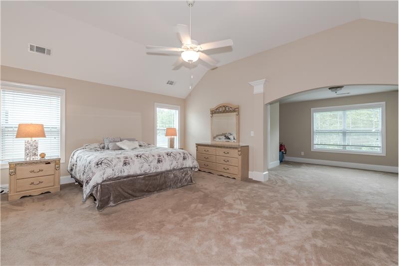 Serene and spacious master suite features a separate sitting room and three walk-in closets.