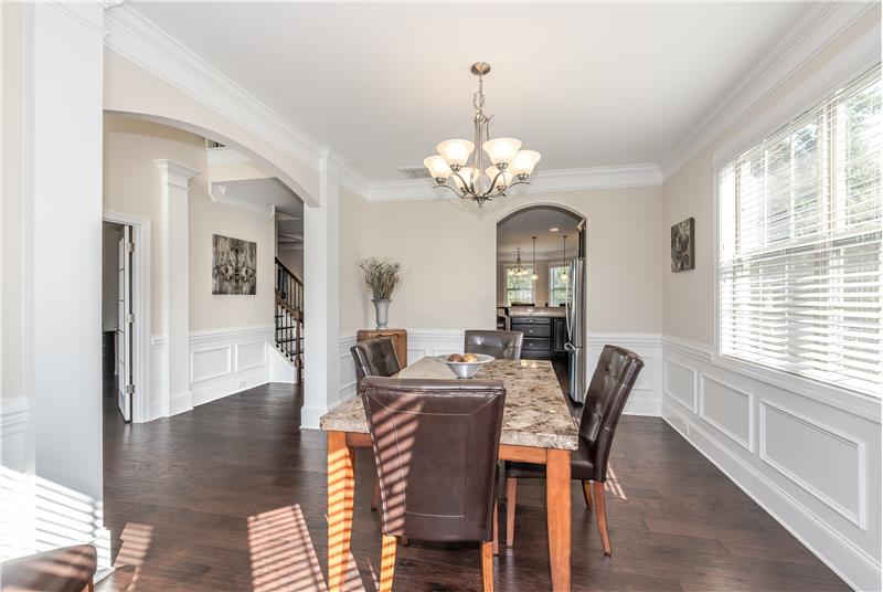 Dining room features custom finishes such as arched doorways. Ideal for holiday gatherings and more formal entertaining.